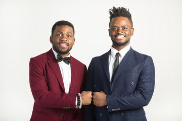 two handsome african men in suits on a white background