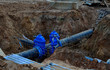 © MaxSafaniuk - Laying underground storm sewers at construction site, water main, sanitary sewer, drain systems.  Groundwater system for new residential buildings in the city. Ball valve background. Small sharpness