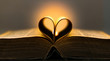Old book pages in a heart shape with a flame in the background 