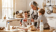 © JenkoAtaman - happy family grandmother and grandchildren cook in the kitchen, knead dough, bake cookies.