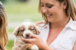 © MACO - Young girl holding a puppy. Bridger, Montana, USA