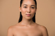 © LIGHTFIELD STUDIOS - beautiful naked asian girl looking at camera isolated on beige