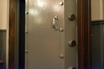 Opened old-fashioned solid vault door of a bank.