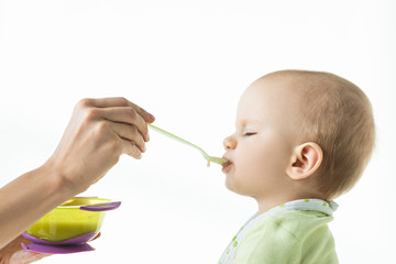 Side view of mother feeding baby with baby nutrition isolated on white