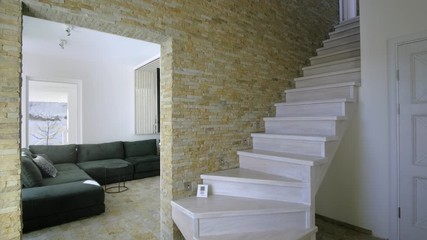 Sticker - Stylish wooden contemporary staircase inside loft house interior. Modern hallway with decorative limestone brick walls and white oak stairs.