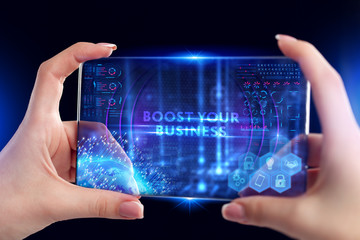 Business, Technology, Internet and network concept. Young businessman working on a virtual screen of the future and sees the inscription: Boost your business