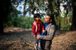 © abir - An Indian brunette father and his baby boy in winter garments enjoying themselves in winter afternoon on a  dry grass field in forest background. Indian lifestyle and parenthood.