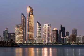 Poster - Breathtaking shot of the cityscape and the Breakwater Beach in Abu Dhabi at night