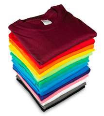 Wall Mural - Stack of many fresh new fabric cotton  t-shirts in colorful rainbow colors isolated. Pile of various colored shirts  white background