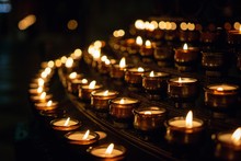 Closeup Shot Of Prayer Candles With Dark Background