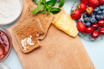 Wall Mural - Healthy breakfast with toasts on cutting board, copy space