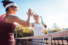 Women Giving High Five After A Good Match Of Tennis