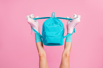 Wall Mural - Cropped view of nice attractive long slender fit legs wearing blue comfortable socks skate rollers holding bag having fun isolated over pink pastel color background