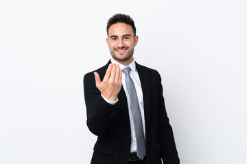 Young business man over isolated background inviting to come