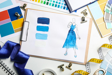 Poster - Flat lay composition with drawing of dress on white table. Designer's workplace