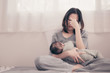 © grooveriderz - Tired Mother Suffering from experiencing postnatal depression.Health care single mom motherhood stressful.