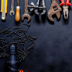 Tools for repair and reconstruction in home conditions lie on a black background