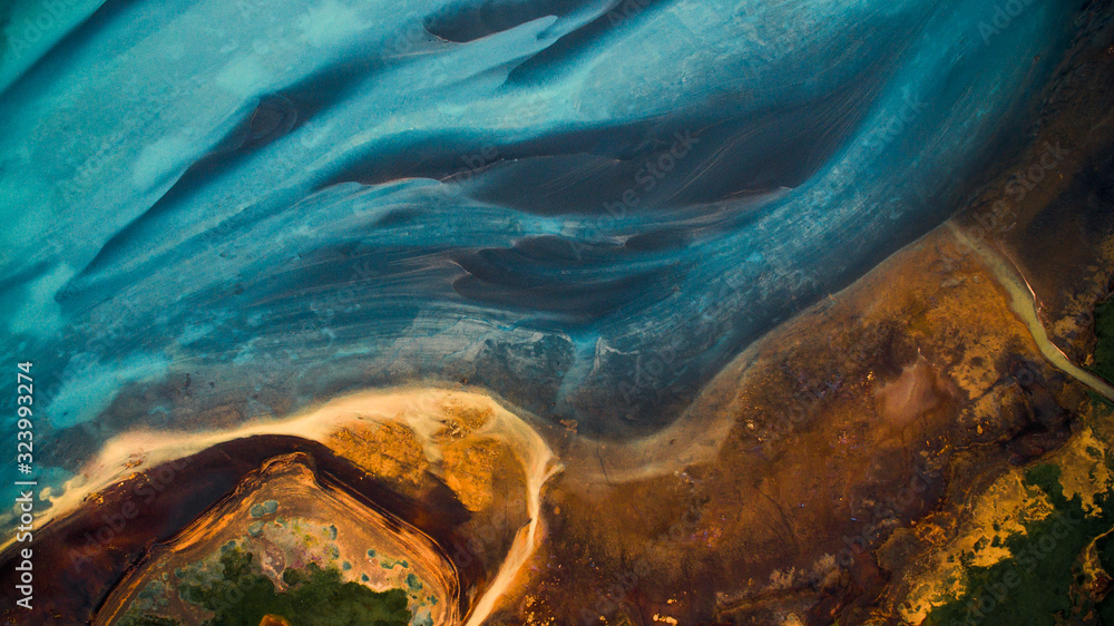 Aerial view from above on a green and blue glacier river stream in  South Iceland. Beautiful patterns, textures and structures. Melting glacier,  Global warming and climate change concept - obrazy, fototapety, plakaty 