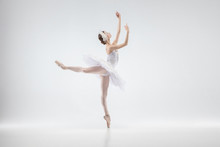 Graceful Classic Ballerina Dancing Isolated On White Studio Background. Woman In Tender Clothes Like A White Swan Characters. The Grace, Artist, Movement, Action And Motion Concept. Looks Weightless.