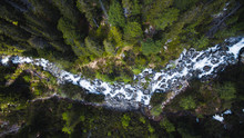 Aerial Top Down Shot Of Flowing Stream River Surrounded By High Trees In Forest, Popradska Pleso,High Tatras, Slovakia