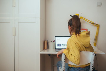 young girl, preteen, sitting desk in her room