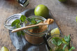 © Luis Mario Hernandez/ADDICTIVE STOCK - Overhead brown sugar in a jar near fresh limes and peppermint leaves placed on napkin on a wooden table