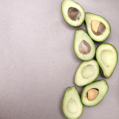 Avocado-ripe and bright, cut in half - on a beige background close-up copy space. Space for text