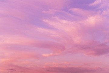 Dramatic sunrise, sunset pink violet sky with clouds background texture