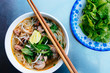 © Mint Images - High angle close up of a bowl of bun bo hue, or beef noodle soup.,Hue