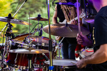 A Close Up Detailed Selective Focus View Of A Man Playing A Drum Kit On Stage During A Festival Celebrating Earth And Alternative Communities