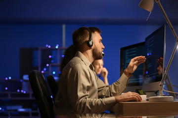 Poster - Technical support agents working in office at night