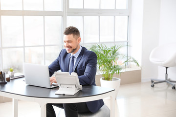 Sticker - Businessman sitting on fitness ball while working in office