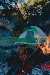 camping with campfire food and a tent