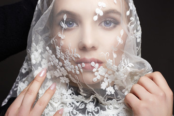 Wall Mural - face of the bride under a veil. beautiful young Woman