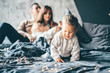 © Mariia Korneeva - Family is having fun in bedroom. Parents with smile play like plane. Mother and father play with son. Young family spend time together on bed. Happy family concept.