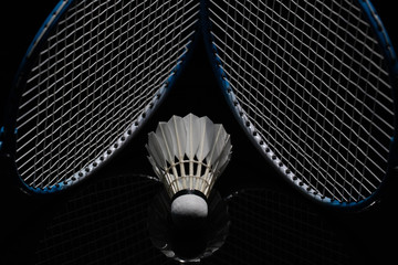 Badminton shuttlecock and badminton racket in the black background used in competition