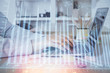 © peshkova - Double exposure of stock market graph with man working on laptop on background. Concept of financial analysis.