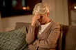 © Syda Productions - pain, stress and people concept - unhappy senior woman suffering from headache at home at night