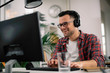 © JustLife - Businessman on video call. Handsome man in office with headphones.