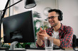 © JustLife - Businessman on video call. Handsome man in office with headphones.