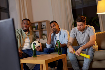 Sticker - friendship, sports and entertainment concept - disappointed male friends with soccer ball and vuvuzela watching football game at home