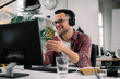 © JustLife - Businessman on video call. Handsome man in office with headphones.