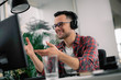 © JustLife - Businessman on video call. Handsome man in office with headphones.