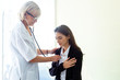© eakgrungenerd - woman doctor using stethoscope examining patient, health and care concept.