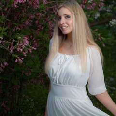 Portrait of beautiful young girl in summer garden.