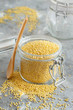 Raw dry hulled millet in a glass jar
