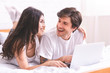 © Prostock-studio - Cheerful couple in love choosing travel route on laptop