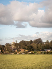 Wall Mural - Ivinghoe village, Buckinghamshire, England. A view of the rural English village set against a fallow crop field and cloudy sky on a sunny winters day.