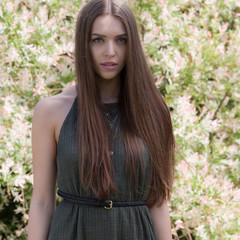 Portrait of beautiful young girl in summer garden.