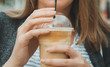 Woman's hand holding cold Frappe Coffee.